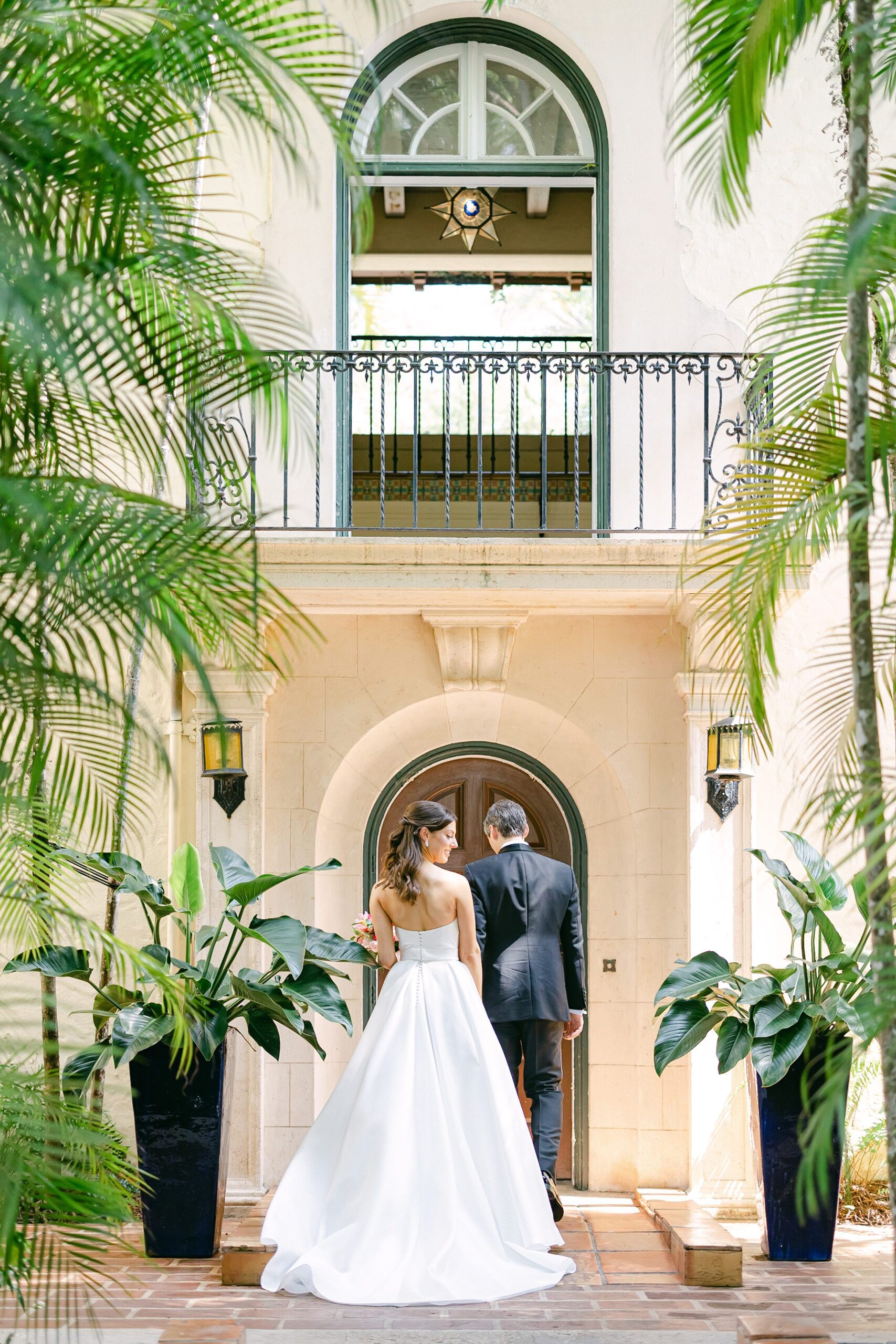 Bride and groom walking toward the Villa Woodbine in a candid moment