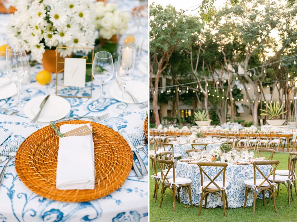 Reception table details featuring chinoiserie table cloth, natural wicker chargers, fresh lemon, white candles and daisies in a Terracotta pot as a centerpiece.