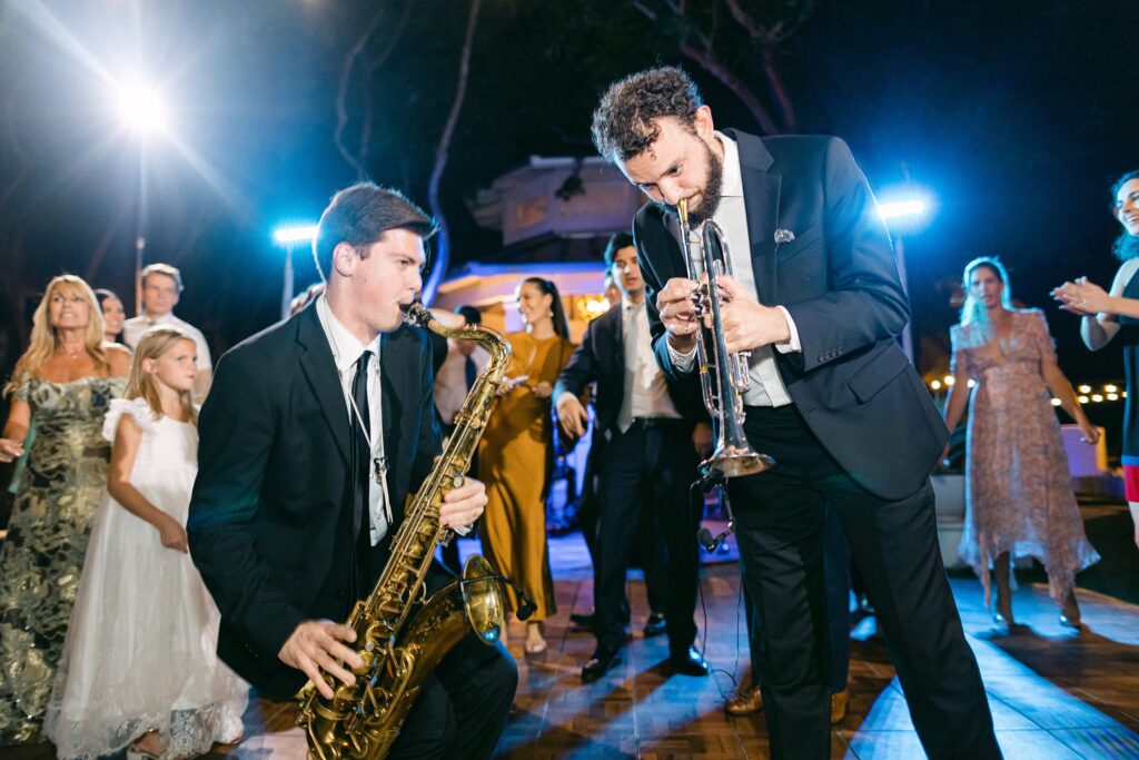 Jazz players performing in the middle of the wedding reception as guests dance