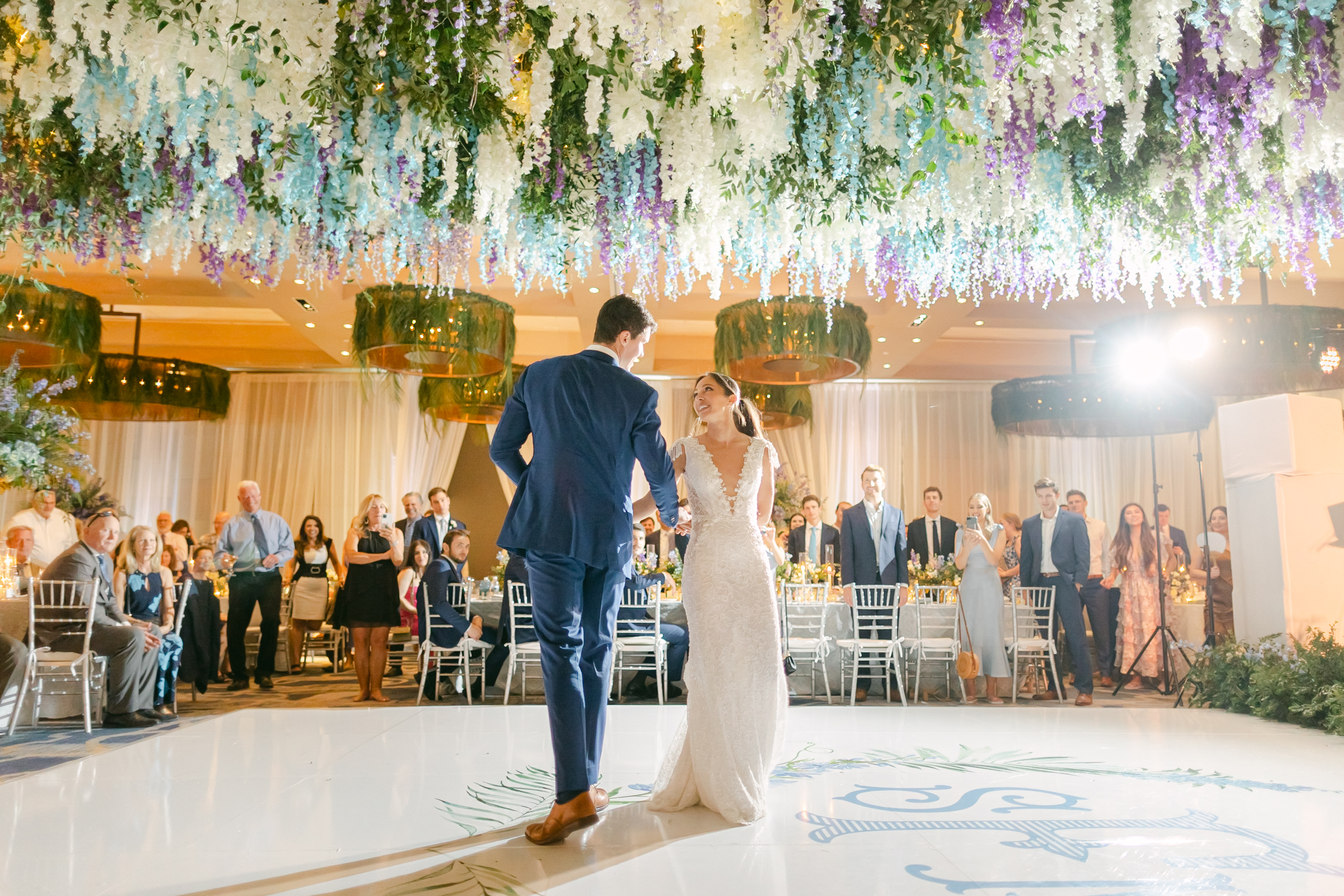 bride and grooms first dance under the Wisteria flower hanging installation