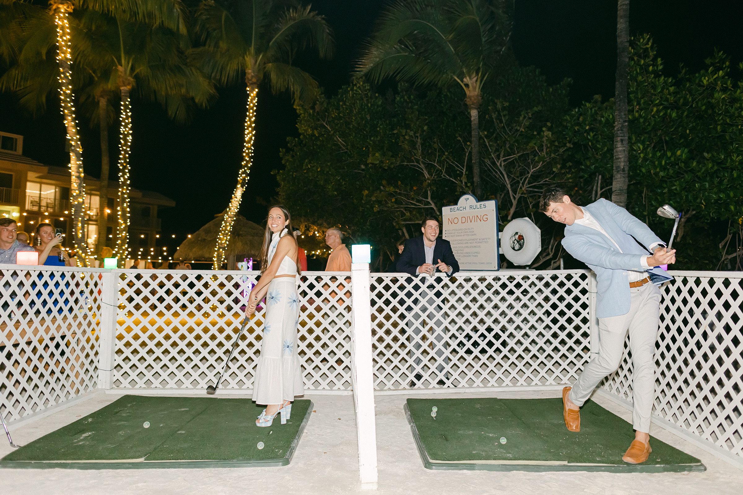 Bride and groom playing glow in the dark golf at their welcome party at ocean reef club