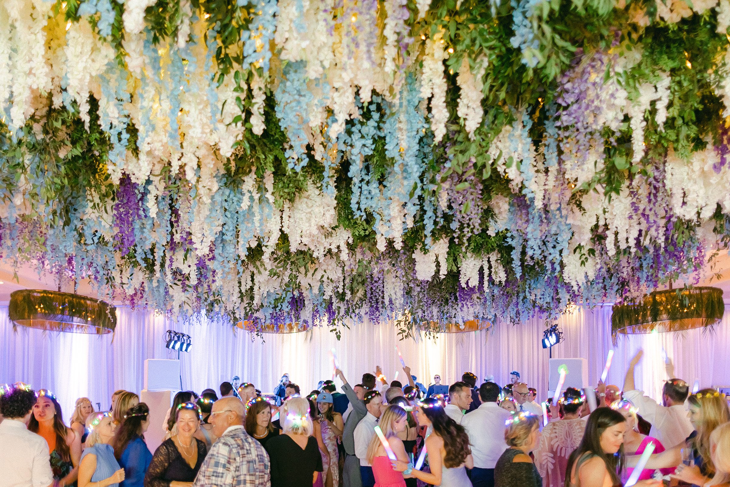 Open reception dancing hora loca under the Wisteria flower ceiling installation