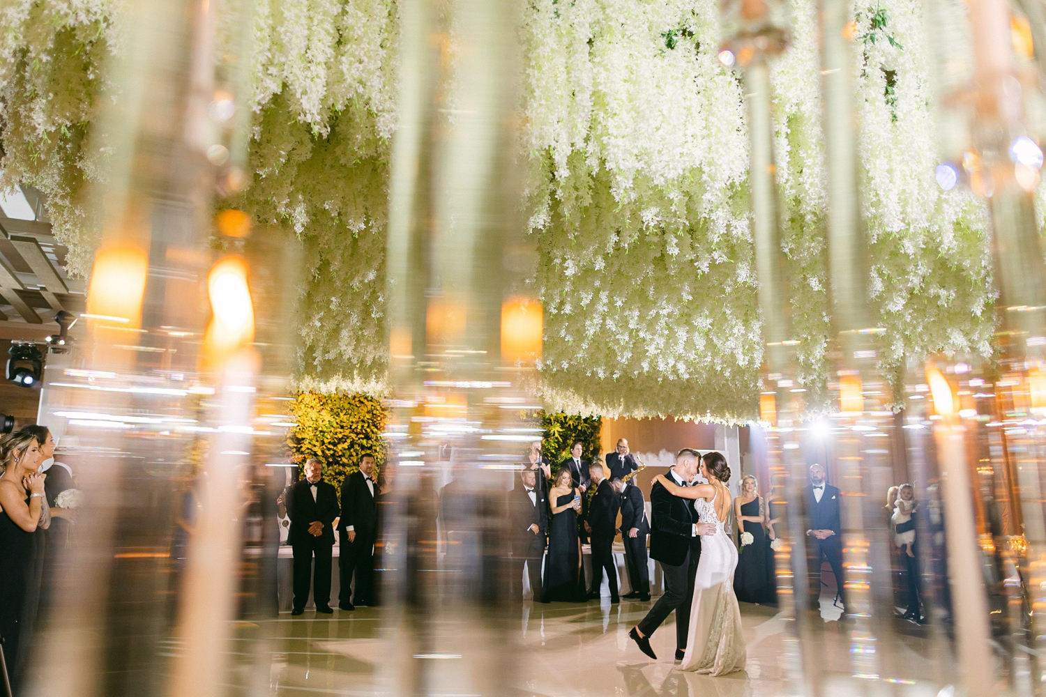 Bride and grooms first dance in the Terra Ballroom under a large white orchid ceiling installation over the dance floor
