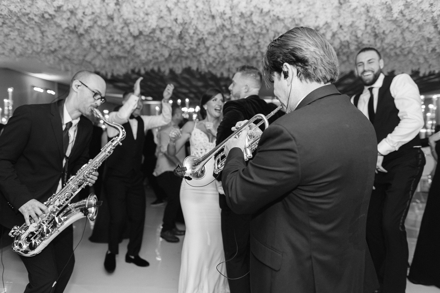 black and white image of the Rock with U Fusion band playing the trumpet on the dance floor with the couple