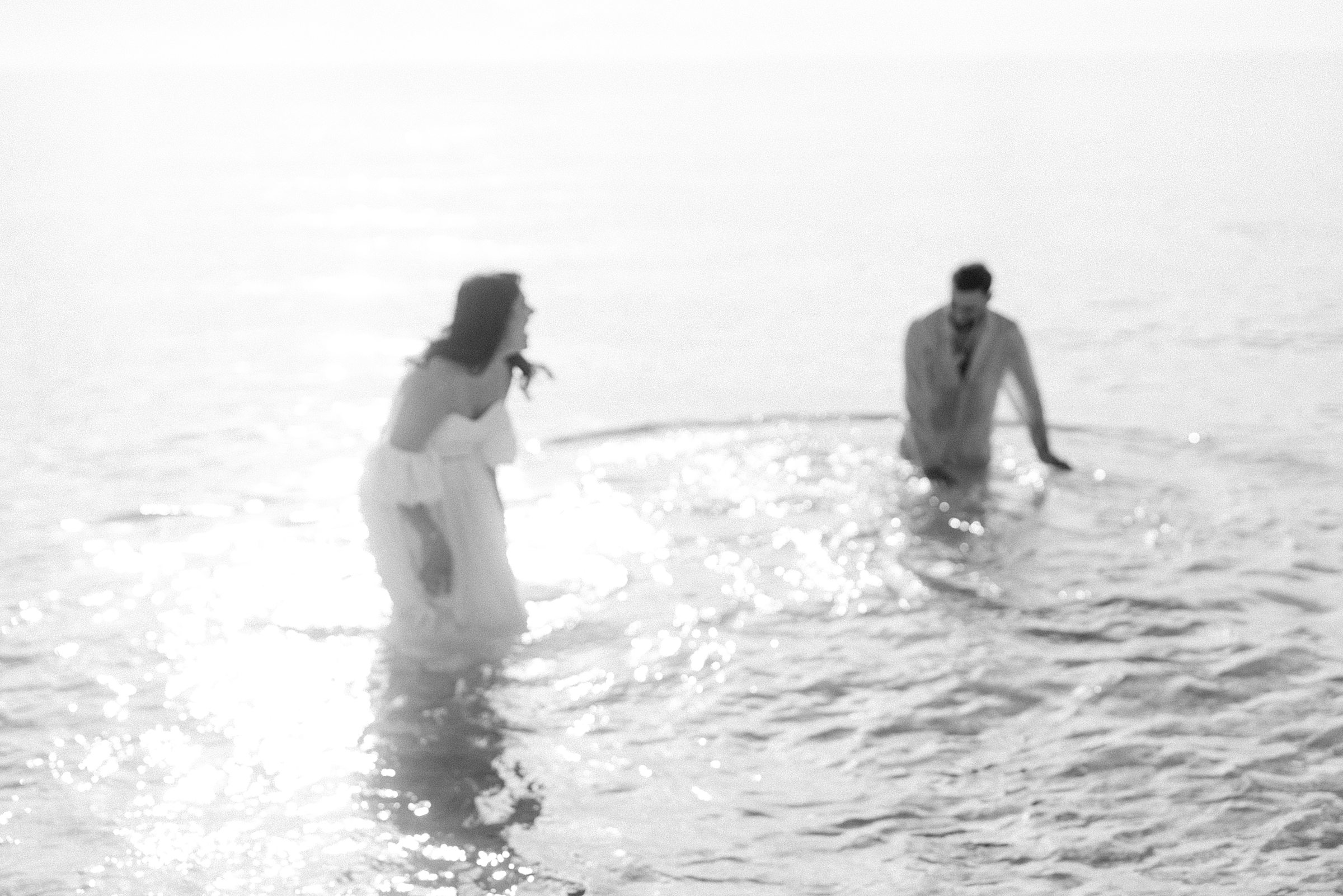 black and white blurry image of the couple playing in the miami beach water
