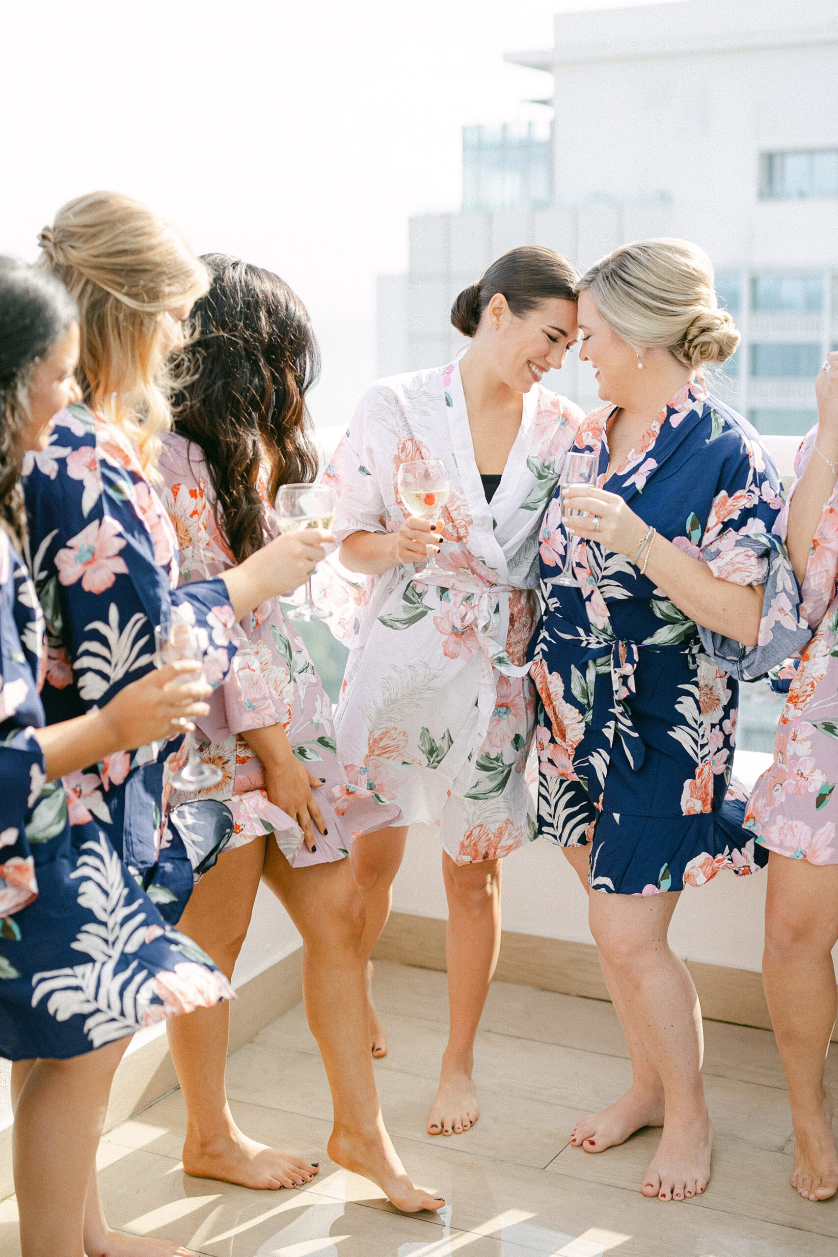 bride and her bridesmaids having a sentimental moment while cheering with champagne 