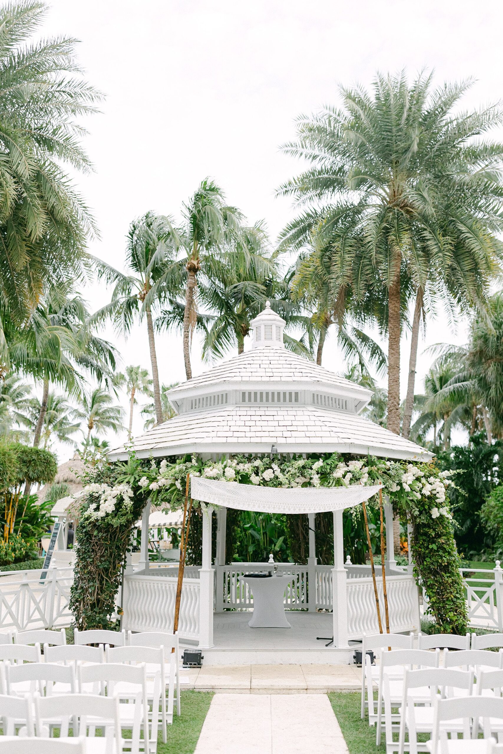 The white gazebo at the palms hotel and spa decorated with a chuppah and white florals