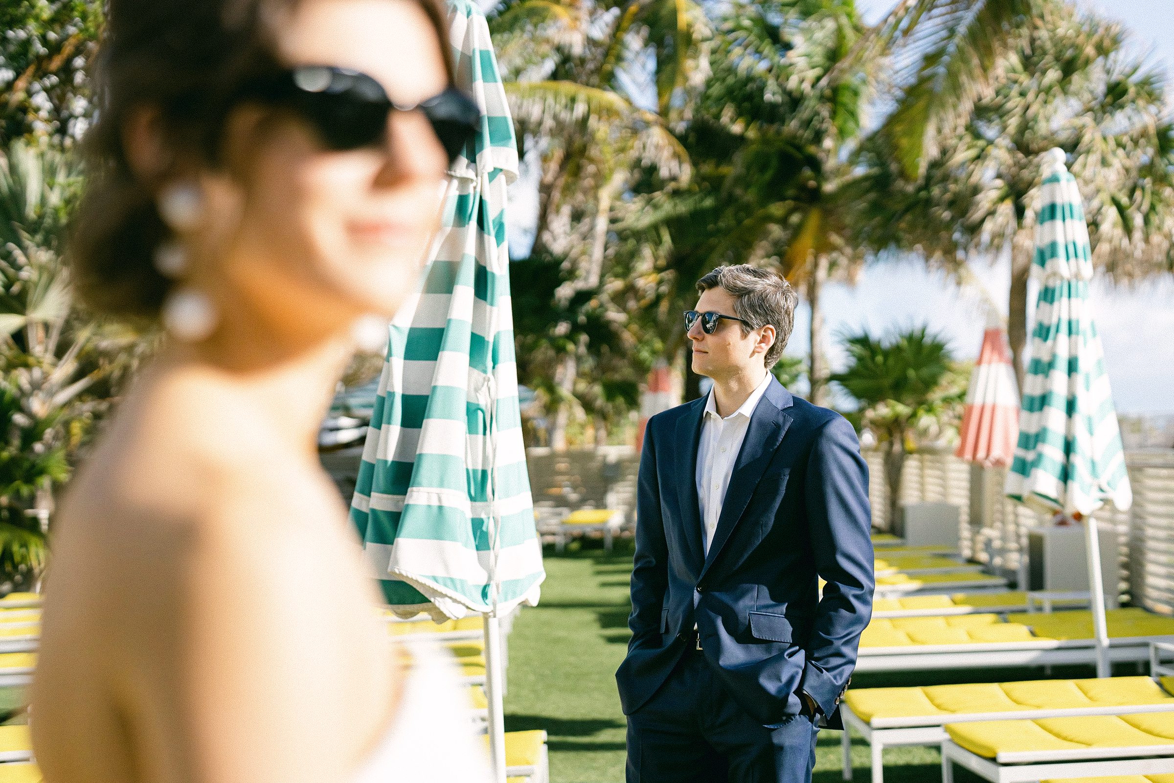 staggered editorial pose of the engaged couple. they are wearing sunglasses